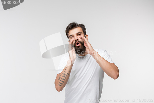 Image of Isolated on pink young casual man shouting at studio