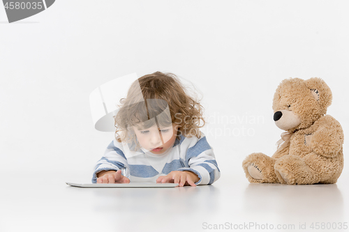 Image of Portrait of happy joyful beautiful little boy sitting with laptop