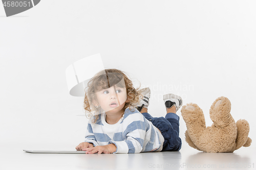 Image of Portrait of happy joyful beautiful little boy sitting with laptop