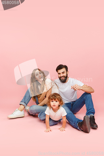 Image of A happy family on pink background