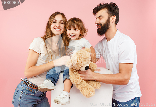 Image of A happy family on pink background