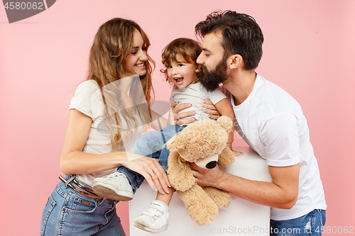 Image of A happy family on pink background