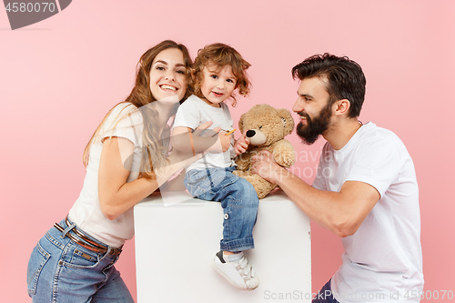 Image of A happy family on pink background