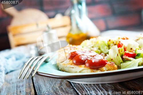 Image of fried chicken breast and salad