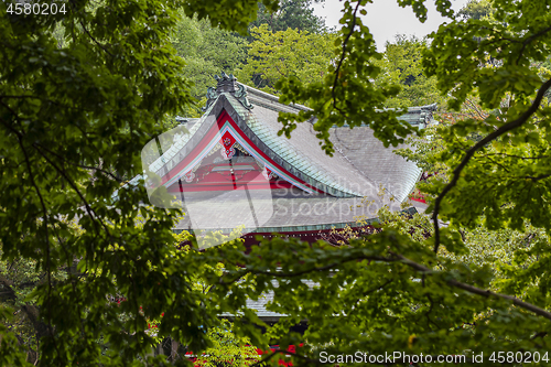 Image of Red japanese temple among the trees in summer