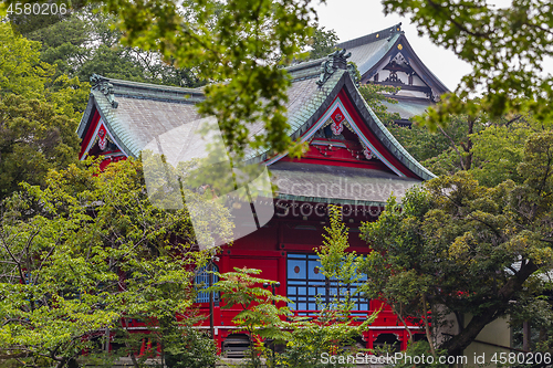 Image of Red japanese temple among the trees in summer