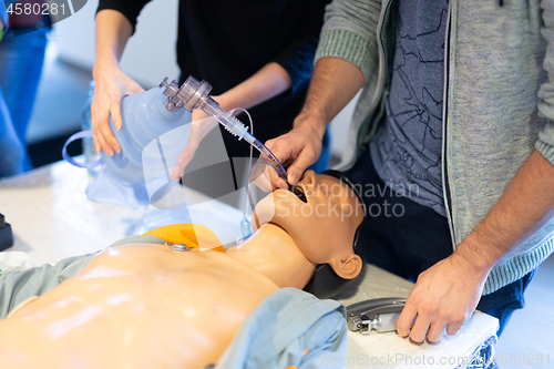 Image of Medical doctor specialist expert displaying method of patient intubation on hands on medical education training and workshop. Participants learning new medical procedures and techniques.