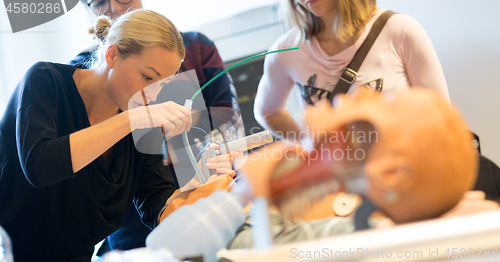 Image of Medical doctor specialist expert displaying method of patient intubation technique on hands on medical education training and workshop