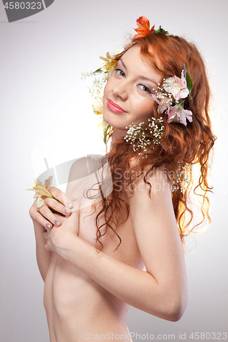 Image of Portrait of beautiful naked woman with spring flowers 