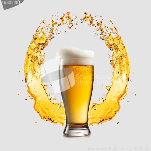 Image of Glass of light beer on a background of splashing logo sign.