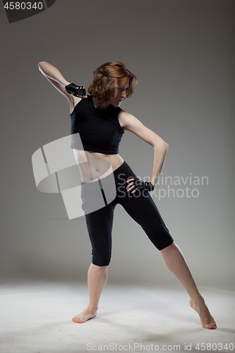 Image of attractive young woman dancing