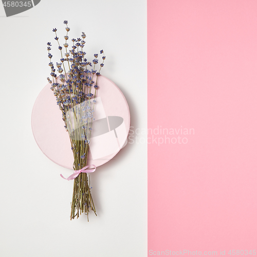 Image of Duotone background with lavender bunch on a round board.