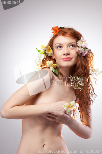 Image of Portrait of beautiful naked woman with spring flowers 