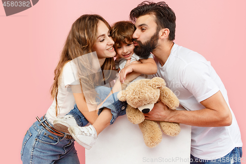 Image of A happy family on pink background