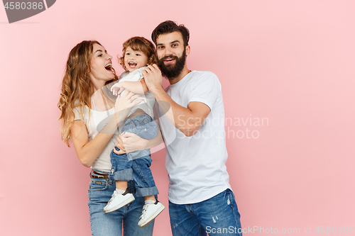 Image of A happy family on pink background