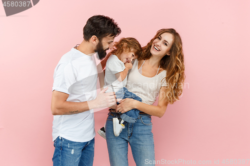 Image of A happy family on pink background