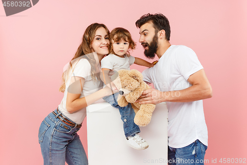 Image of A happy family on pink background
