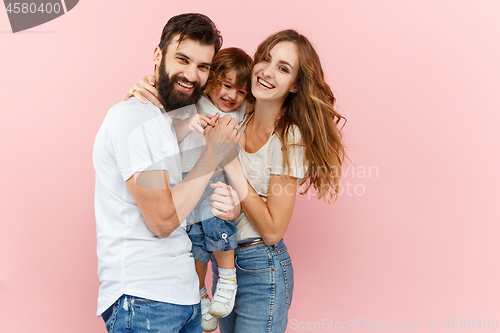 Image of A happy family on pink background