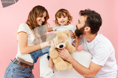 Image of A happy family on pink background