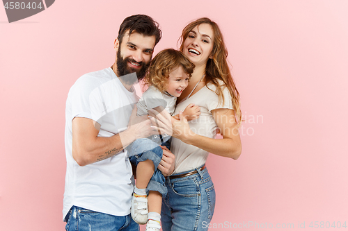 Image of A happy family on pink background