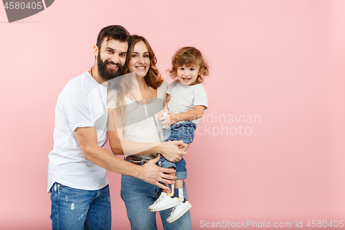 Image of A happy family on pink background