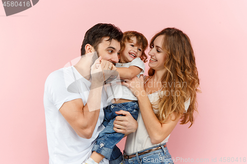 Image of A happy family on pink background