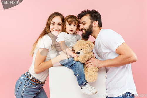 Image of A happy family on pink background