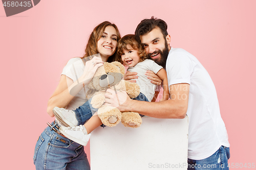 Image of A happy family on pink background