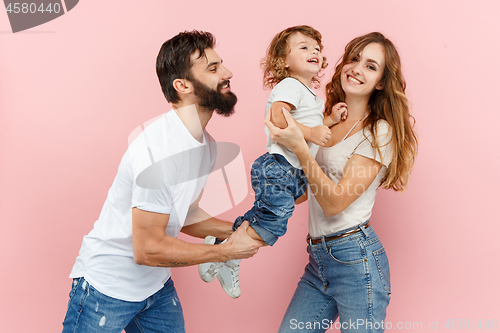 Image of A happy family on pink background