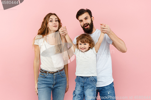 Image of A happy family on pink background