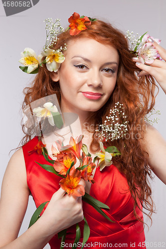 Image of Portrait of beautiful woman with spring flowers 