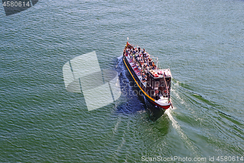 Image of Tourist boat moving on The Duoro river in Porto