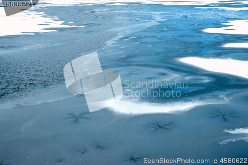 Image of Lake frozen in early winter, blue water color