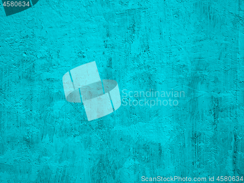 Image of Detail of concrete wall painted in turquoise color