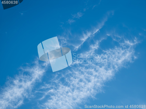 Image of High white clouds in bright blue sky