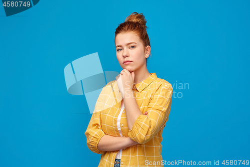 Image of red haired teenage girl in checkered shirt