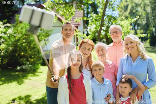 Image of happy family taking selfie in summer garden