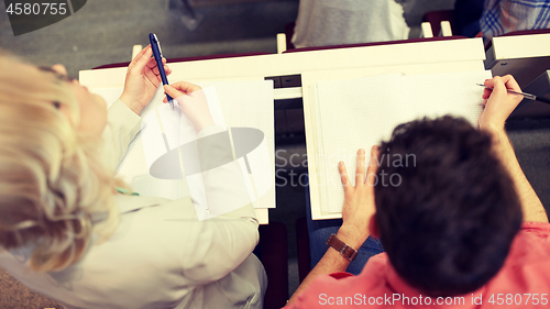 Image of students with notebooks at exam or lecture