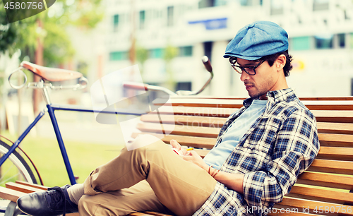 Image of man with notebook or diary writing on city street