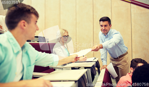 Image of teacher giving tests to students at lecture