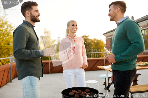 Image of happy friends having bbq party on rooftop