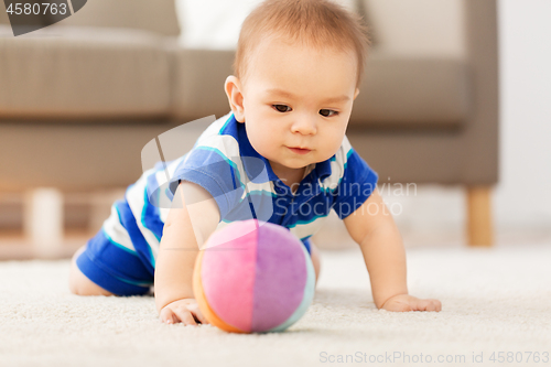 Image of sweet little asian baby boy playing with toy ball