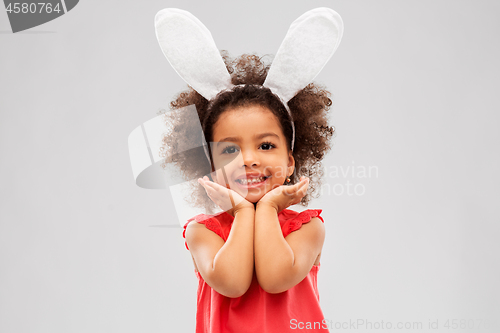 Image of happy little girl wearing easter bunny ears posing