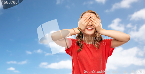 Image of smiling teenage girl in red t-shirt over sky