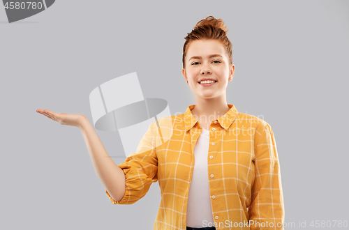 Image of red haired teenage girl holding empty hands