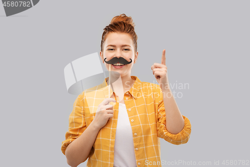 Image of teenage girl with moustaches pointing finger up