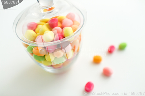 Image of close up of glass jar with colorful candy drops