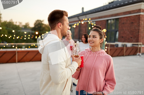 Image of friends with non alcoholic drinks at rooftop party