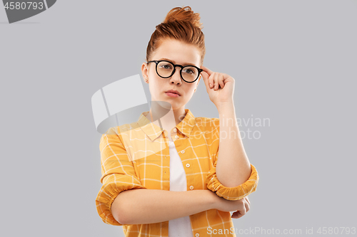 Image of red haired teenage student girl in glasses