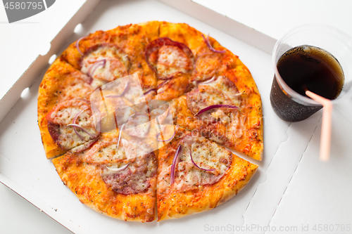 Image of close up of takeaway pizza in box with cup of cola